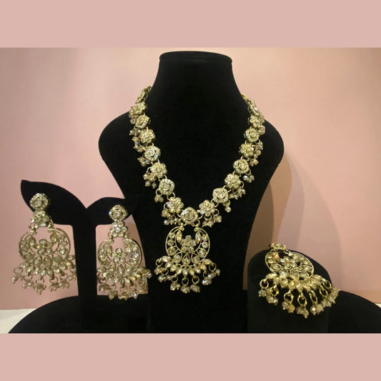 Gold pearl necklace with moon earrings and maang tikka
